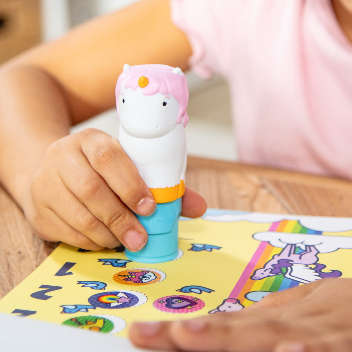 Child stamping unicorn stickers with the Sticker WOW! stamper