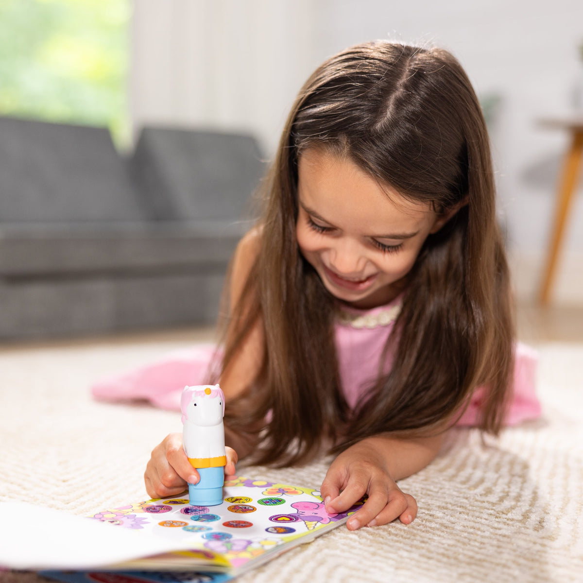 Child playing with Sticker WOW! Unicorn
